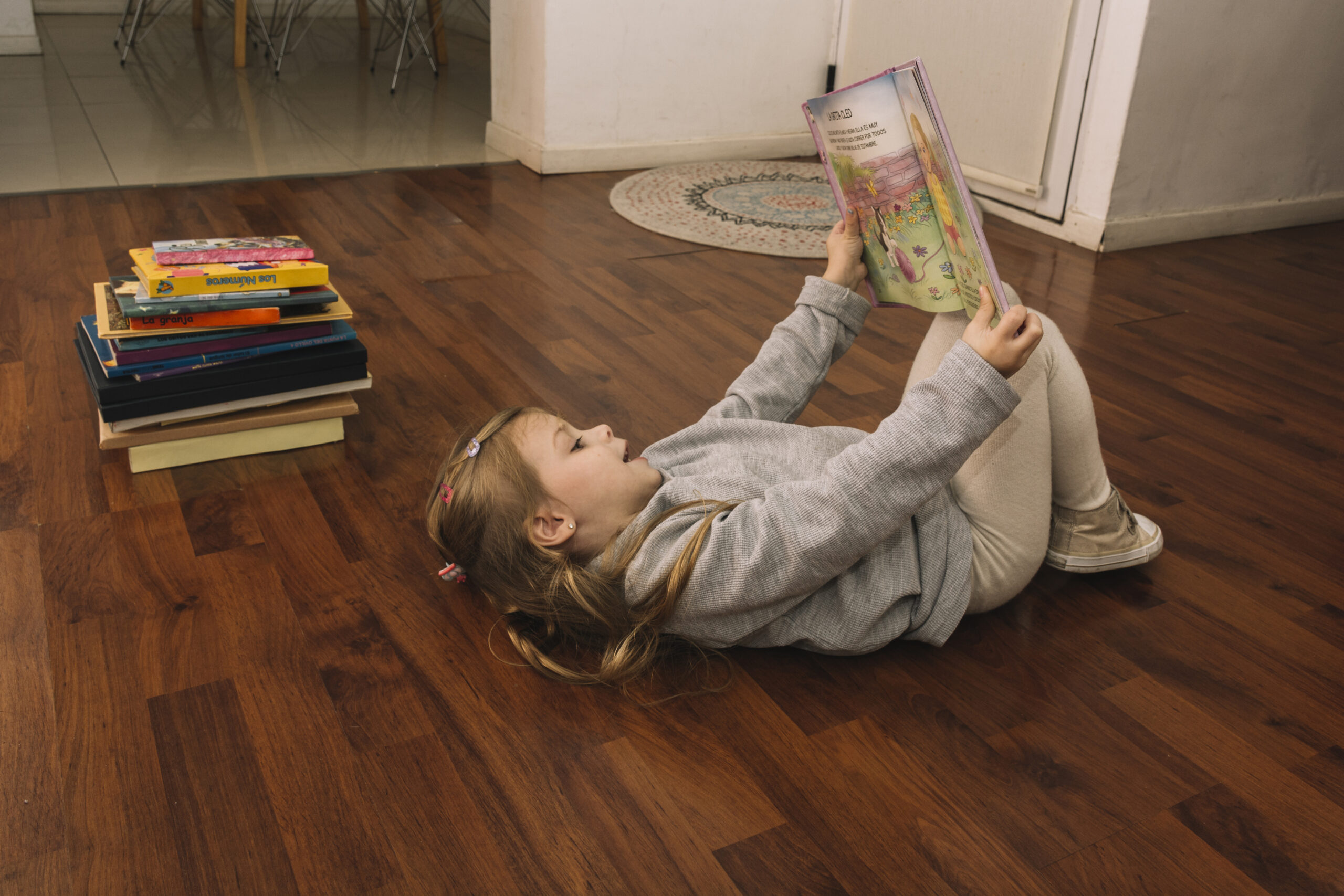 girl with book lying floor